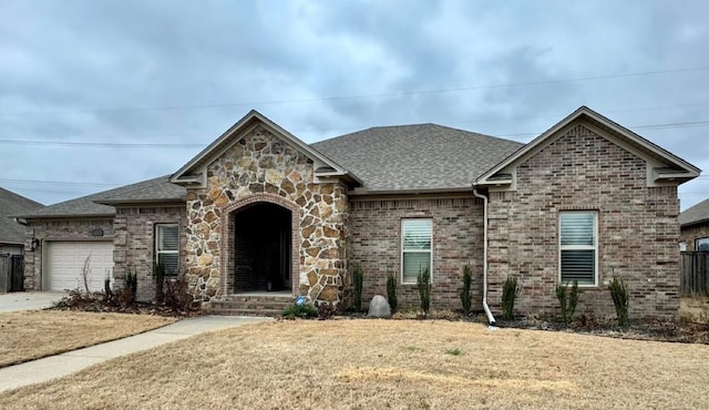 view of front of home with a garage and a front yard