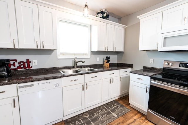 kitchen featuring sink, decorative light fixtures, dark hardwood / wood-style floors, white appliances, and white cabinets