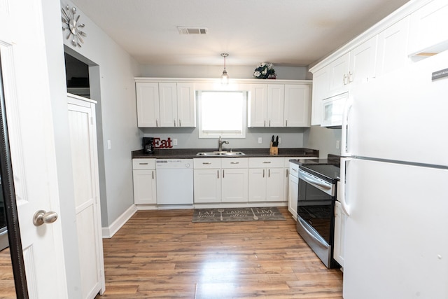 kitchen featuring sink, white cabinets, white appliances, and light wood-type flooring