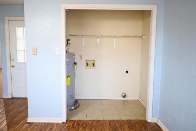 laundry room featuring washer hookup, light hardwood / wood-style floors, water heater, and electric dryer hookup