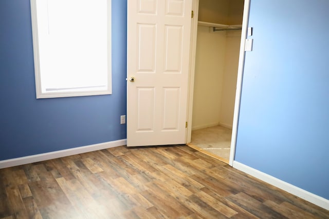 unfurnished bedroom with wood-type flooring and a closet