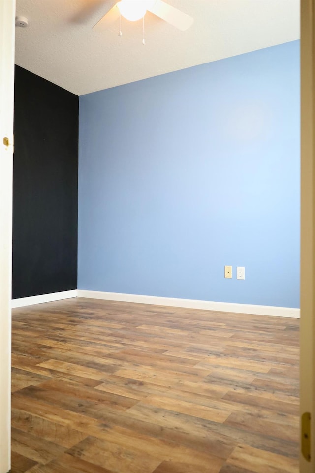 unfurnished room with wood-type flooring and ceiling fan