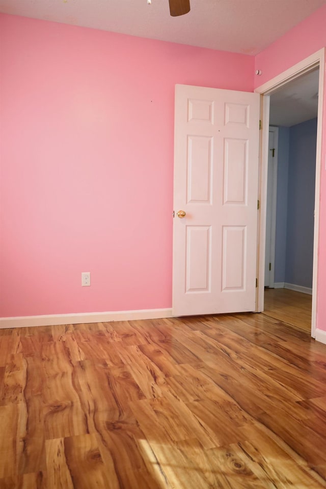 unfurnished bedroom with ceiling fan and wood-type flooring