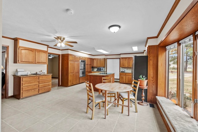 dining space featuring ceiling fan, ornamental molding, and light tile patterned floors