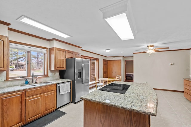 kitchen featuring sink, appliances with stainless steel finishes, backsplash, ornamental molding, and a kitchen island