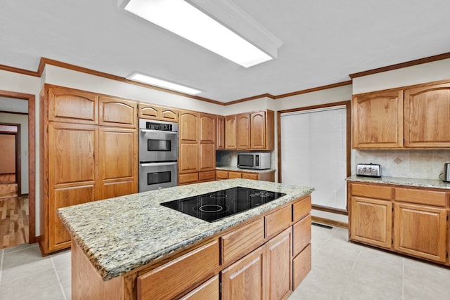 kitchen featuring crown molding, light tile patterned floors, a kitchen island, stainless steel appliances, and light stone countertops