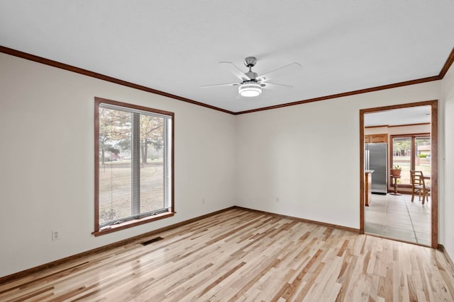 empty room with ornamental molding, ceiling fan, and light hardwood / wood-style floors