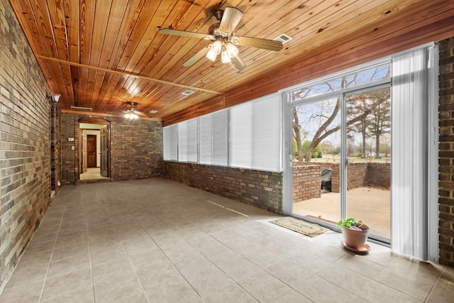 unfurnished sunroom with ceiling fan and wood ceiling