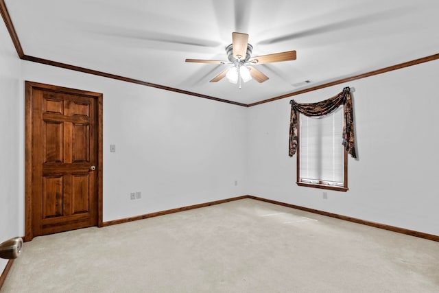 spare room with ornamental molding, light colored carpet, and ceiling fan