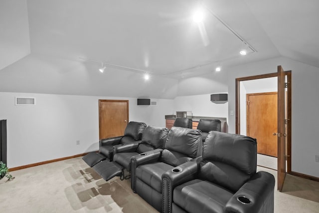 carpeted home theater with vaulted ceiling