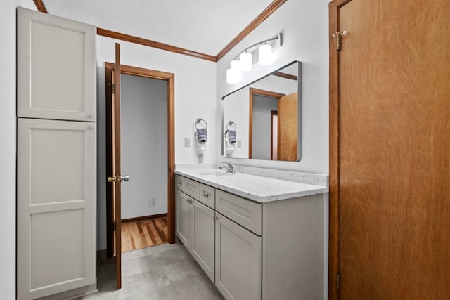 bathroom featuring crown molding and vanity