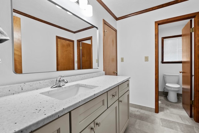 bathroom with ornamental molding, toilet, and vanity