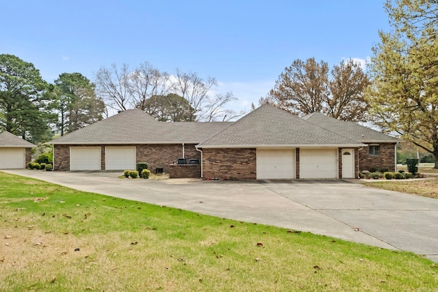 ranch-style home featuring a garage and a front lawn