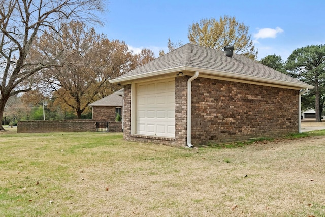 view of side of property with a garage and a yard