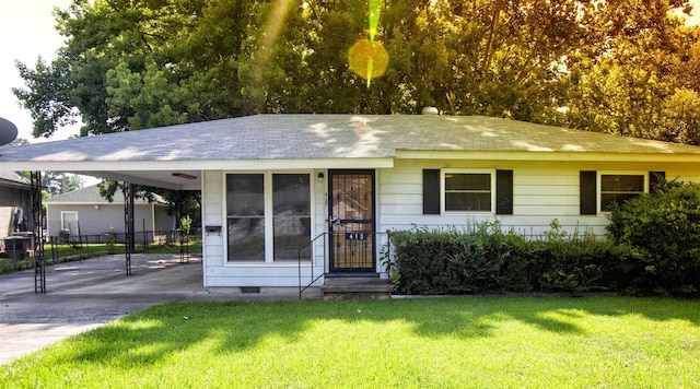 single story home featuring a front yard and a carport