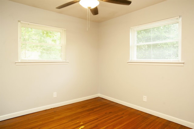 empty room with hardwood / wood-style flooring and ceiling fan