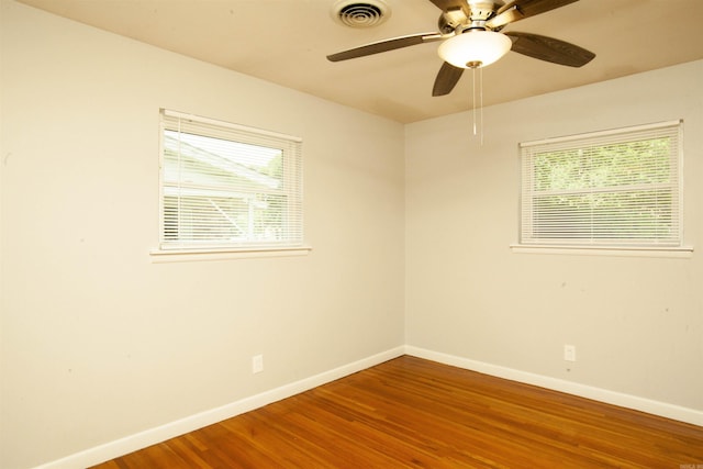 unfurnished room with ceiling fan and hardwood / wood-style floors