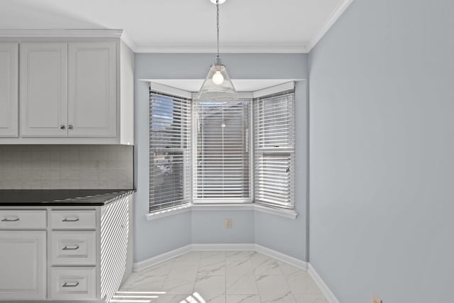 unfurnished dining area featuring crown molding