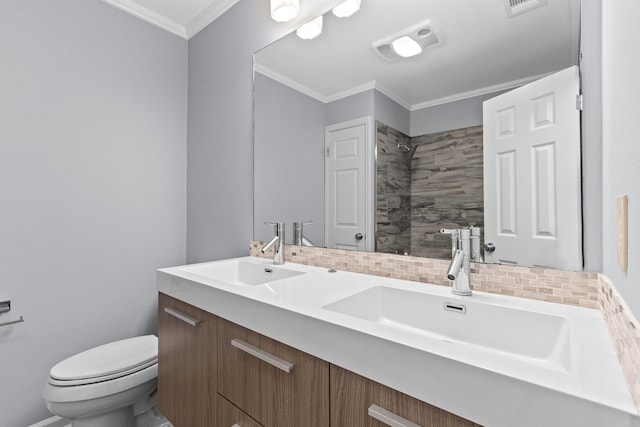 bathroom featuring ornamental molding, toilet, vanity, and backsplash