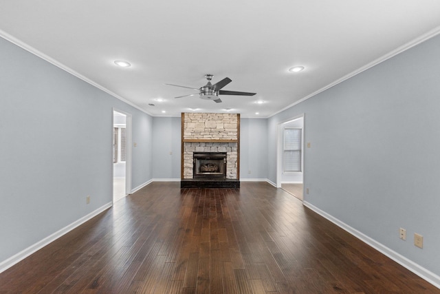 unfurnished living room with dark hardwood / wood-style flooring, crown molding, a fireplace, and ceiling fan