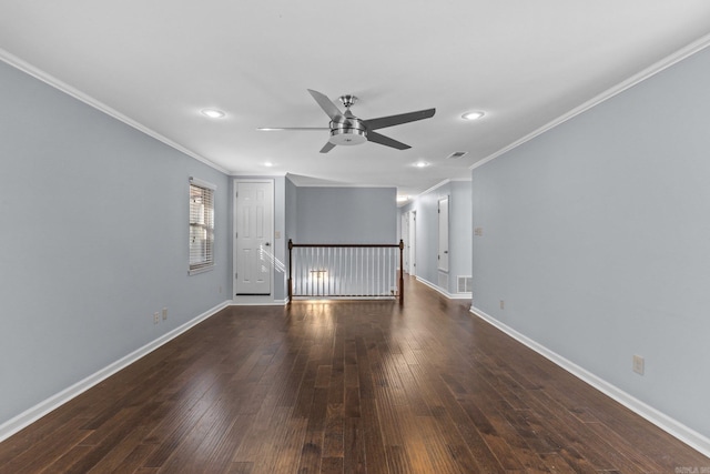 spare room with crown molding, dark wood-type flooring, and ceiling fan