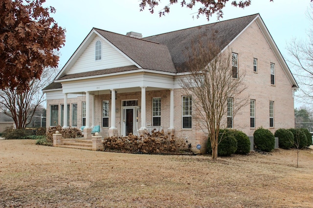 view of front facade with a front yard and a porch