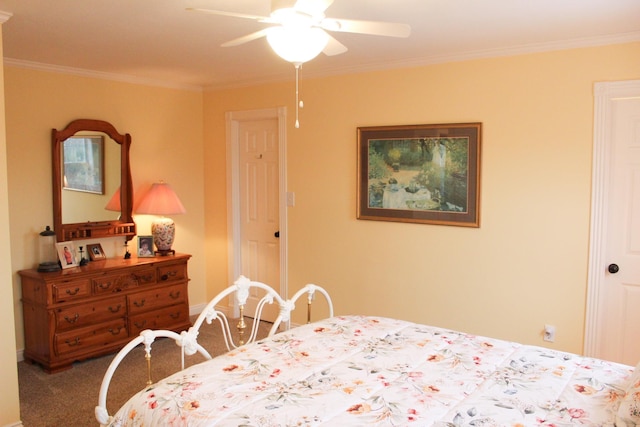 carpeted bedroom with ornamental molding and ceiling fan