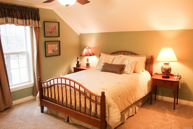 bedroom featuring multiple windows, vaulted ceiling, and light colored carpet