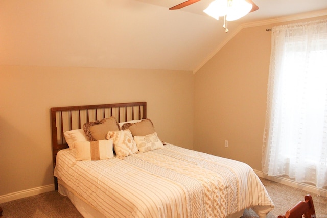 carpeted bedroom with vaulted ceiling and ceiling fan