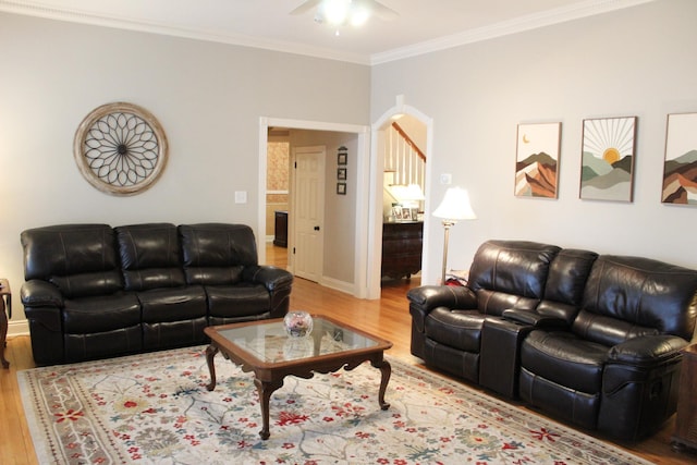 living room with hardwood / wood-style floors, crown molding, and ceiling fan