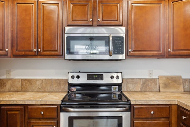 kitchen with stainless steel appliances and tile countertops