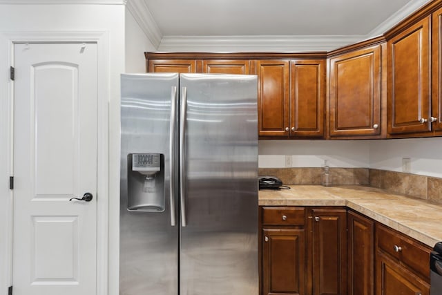 kitchen with crown molding and stainless steel fridge