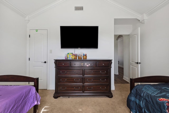 bedroom featuring lofted ceiling, crown molding, and light carpet