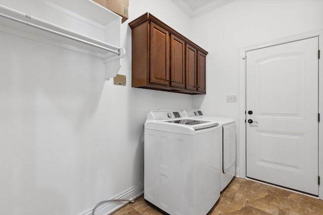 washroom with cabinets, crown molding, and washer and dryer