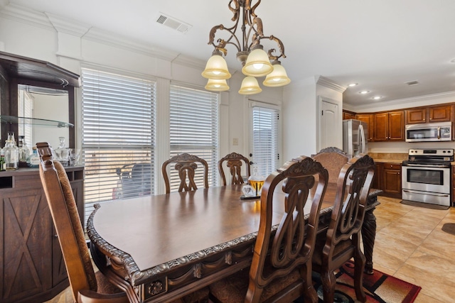 tiled dining area with ornamental molding and a chandelier