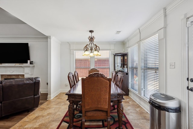 dining area featuring an inviting chandelier, crown molding, and light tile patterned flooring