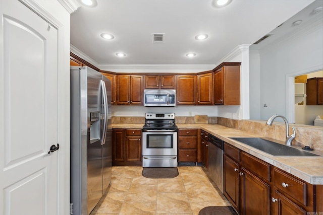 kitchen featuring sink, crown molding, and stainless steel appliances