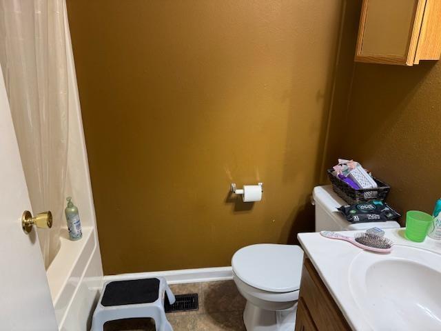 bathroom with tile patterned flooring, vanity, and toilet