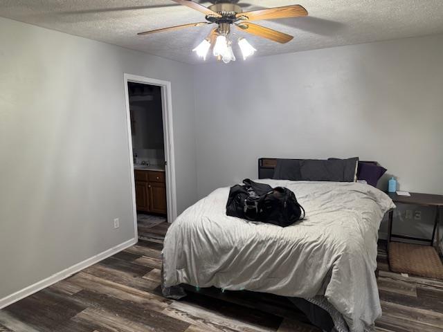 bedroom with ensuite bathroom, ceiling fan, a textured ceiling, and dark hardwood / wood-style flooring