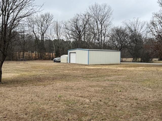 view of yard with a garage and an outdoor structure