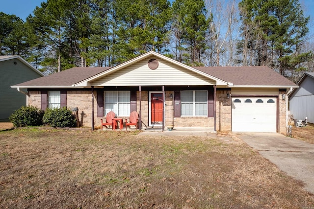 ranch-style house featuring a garage, a porch, and a front lawn