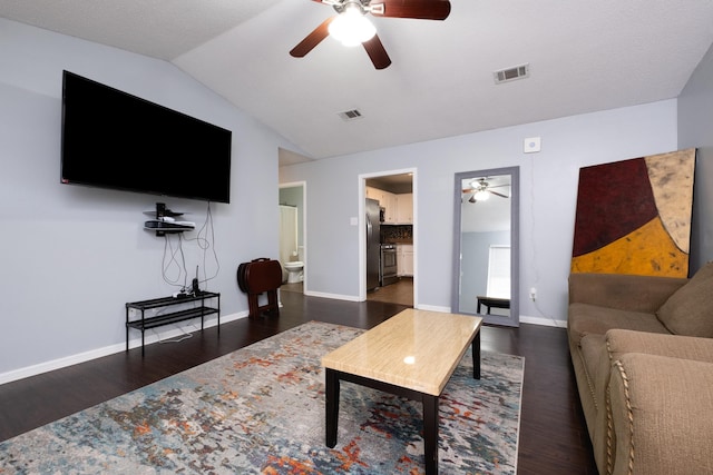 living room with dark hardwood / wood-style flooring, vaulted ceiling, and ceiling fan