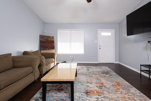 living room with dark wood-type flooring and ceiling fan