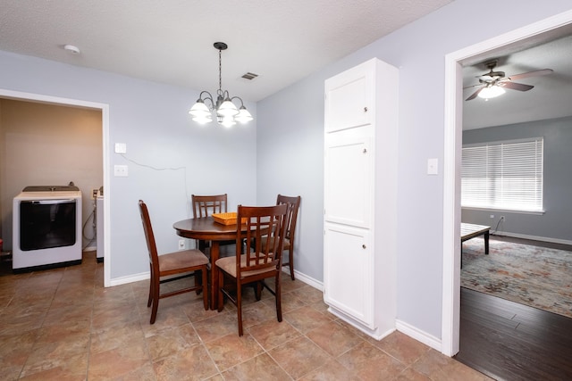 dining room featuring separate washer and dryer, a textured ceiling, and a notable chandelier