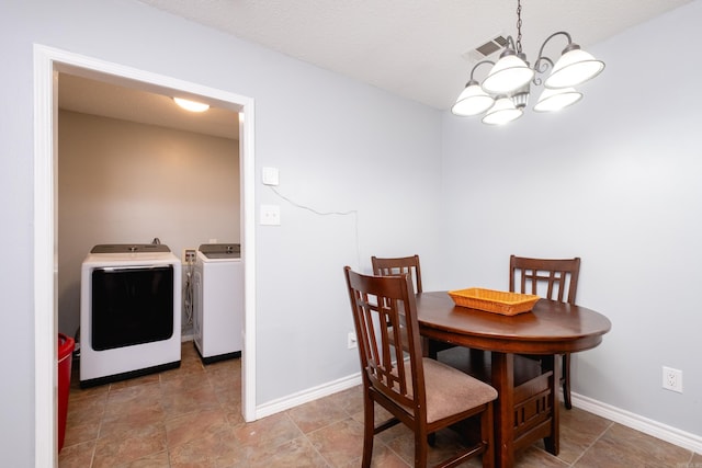 dining room featuring an inviting chandelier and washing machine and clothes dryer