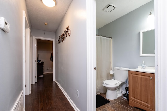 interior space featuring dark wood-type flooring and a textured ceiling