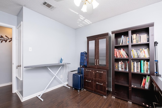 miscellaneous room with ceiling fan, dark hardwood / wood-style flooring, and a textured ceiling