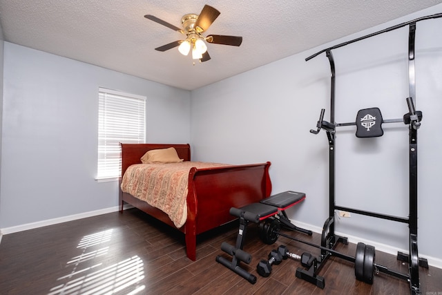 bedroom featuring ceiling fan, a textured ceiling, and dark hardwood / wood-style flooring