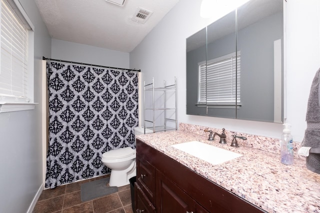 bathroom featuring tile patterned flooring, vanity, toilet, a textured ceiling, and a shower with shower curtain