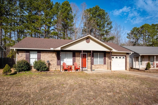 single story home featuring a garage, a front lawn, and covered porch